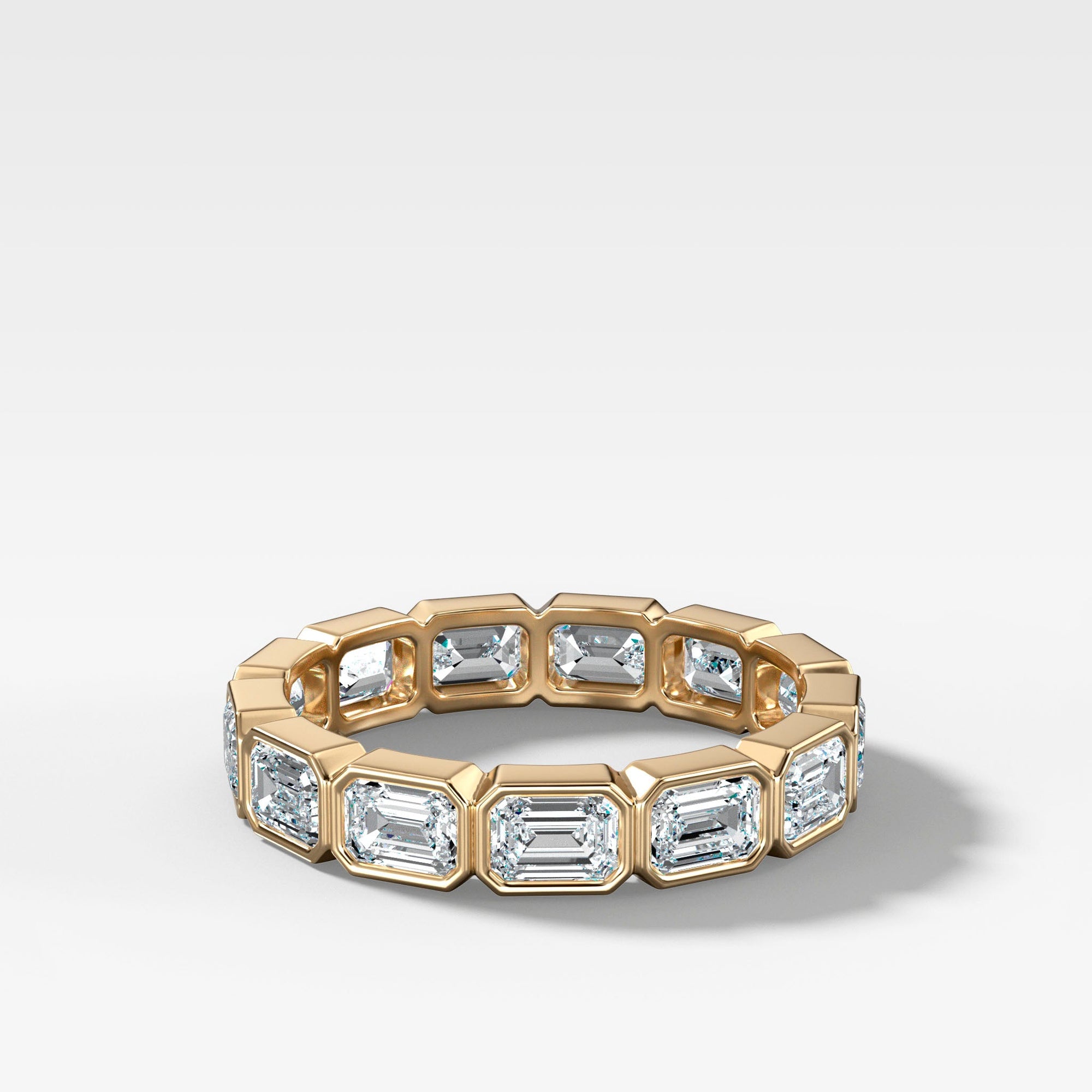 Midi Bezel Set Eternity Band With East West Emerald Cuts in Yellow Gold by Good Stone