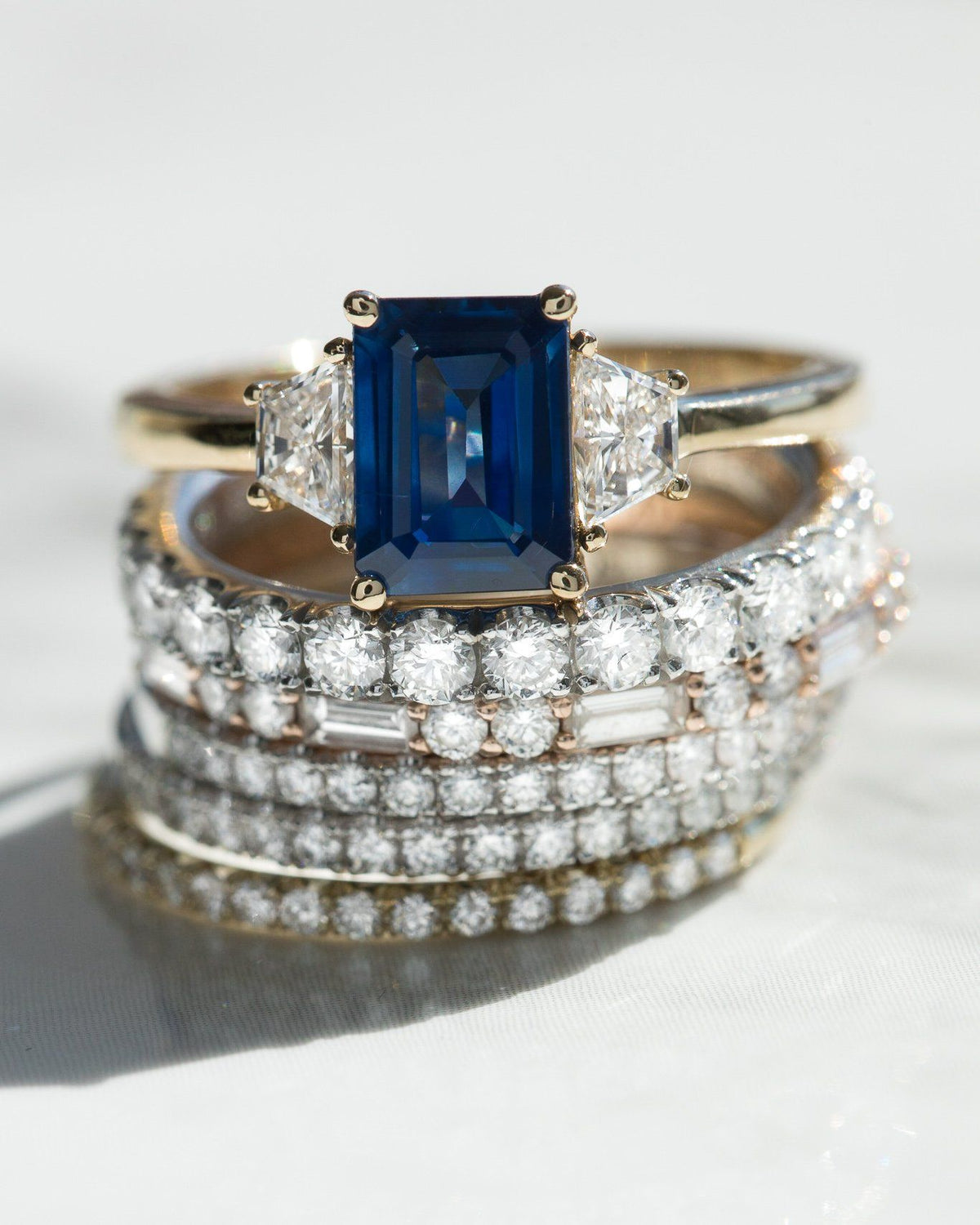 Sapphire Emerald Cut With Trapezoid Side Stone Engagement Ring by Good Stone available in Gold and Platinum