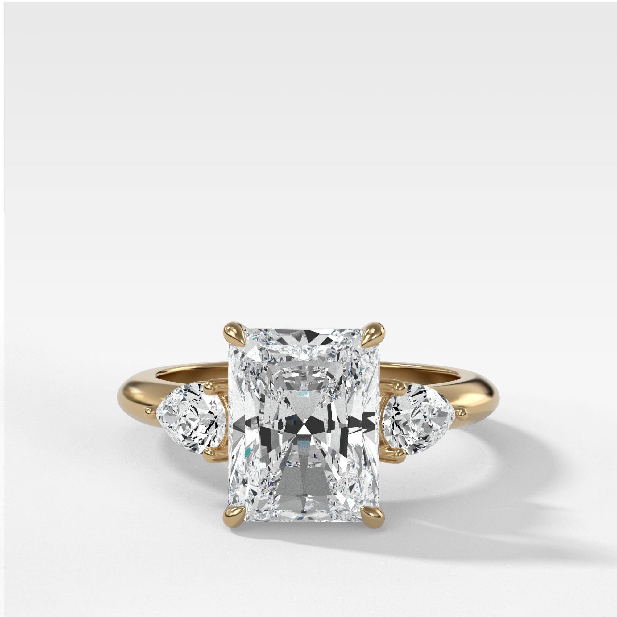 Three Stone Engagement Ring With Pear Side Stones and Radiant Cut by Good Stone in Yellow Gold
