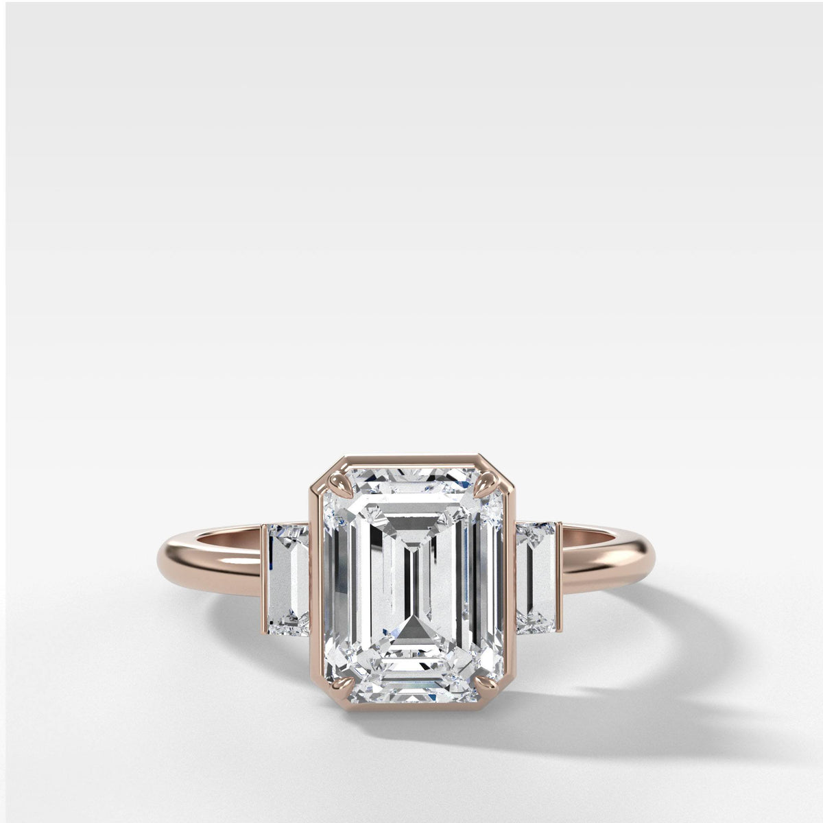 Three Stone Engagement Ring With Straight Baguette Side Stones and Emerald Cut by Good Stone in Rose Gold