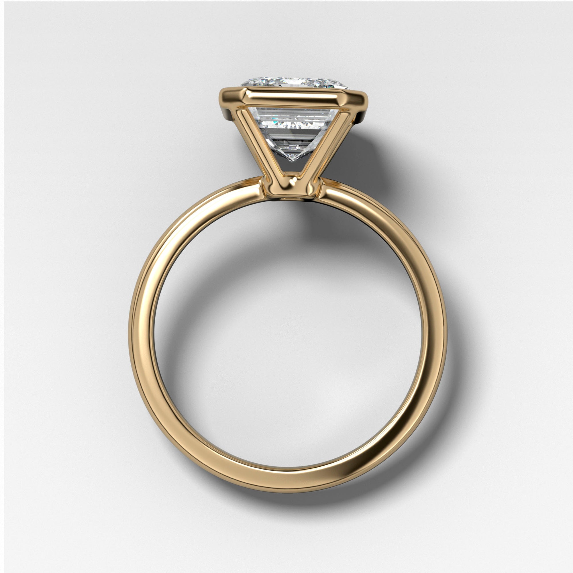 Bezel Penumbra Solitaire With Emerald Cut in Yellow Gold by Good Stone