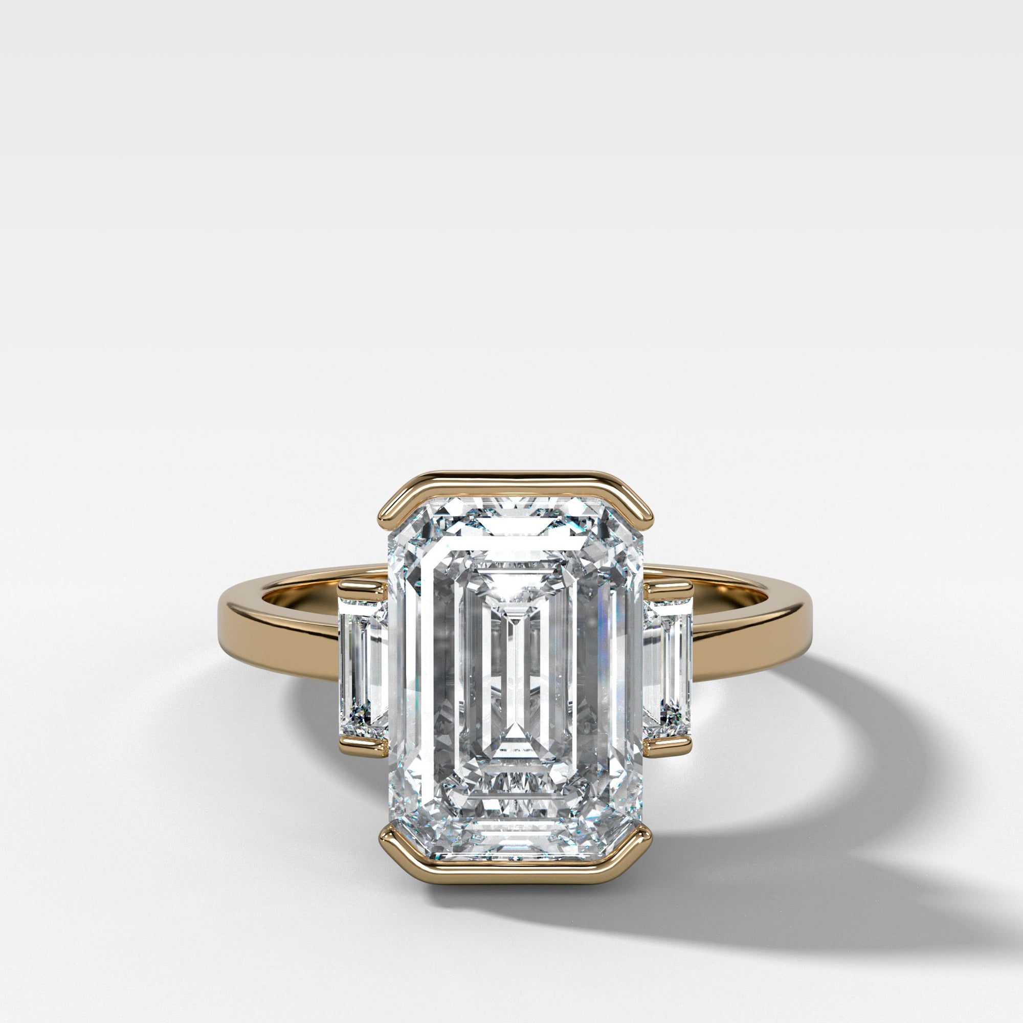 Three Stone Engagement Ring with Mini Half Bezel Baguette Side Stones and Emerald Cut Diamond