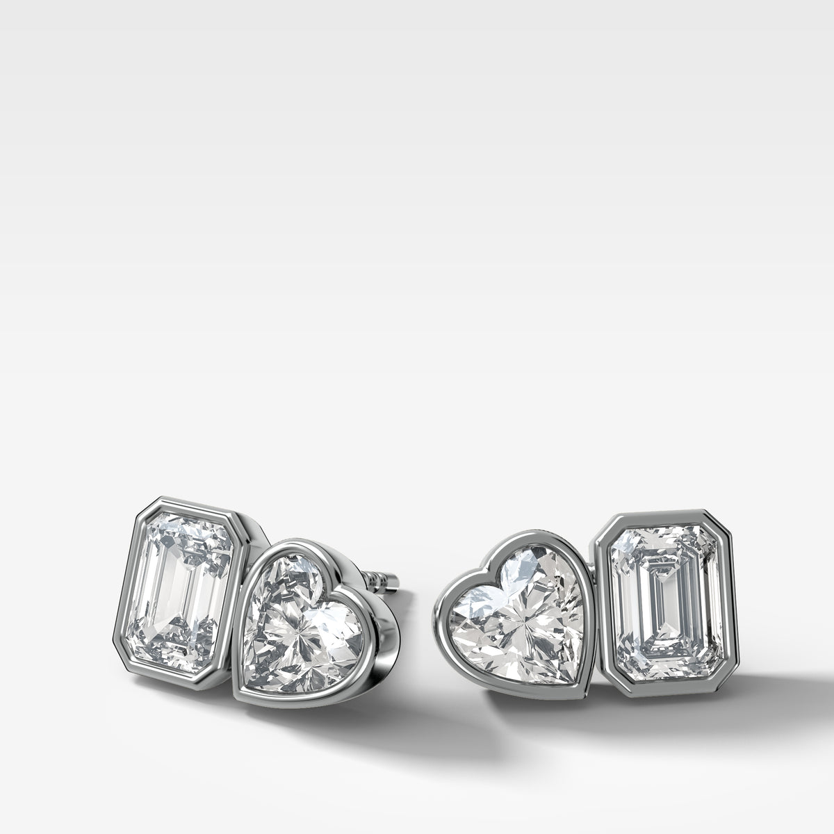 Toi et Moi Bezel Set Diamond Studs with Emerald and Heart Cuts