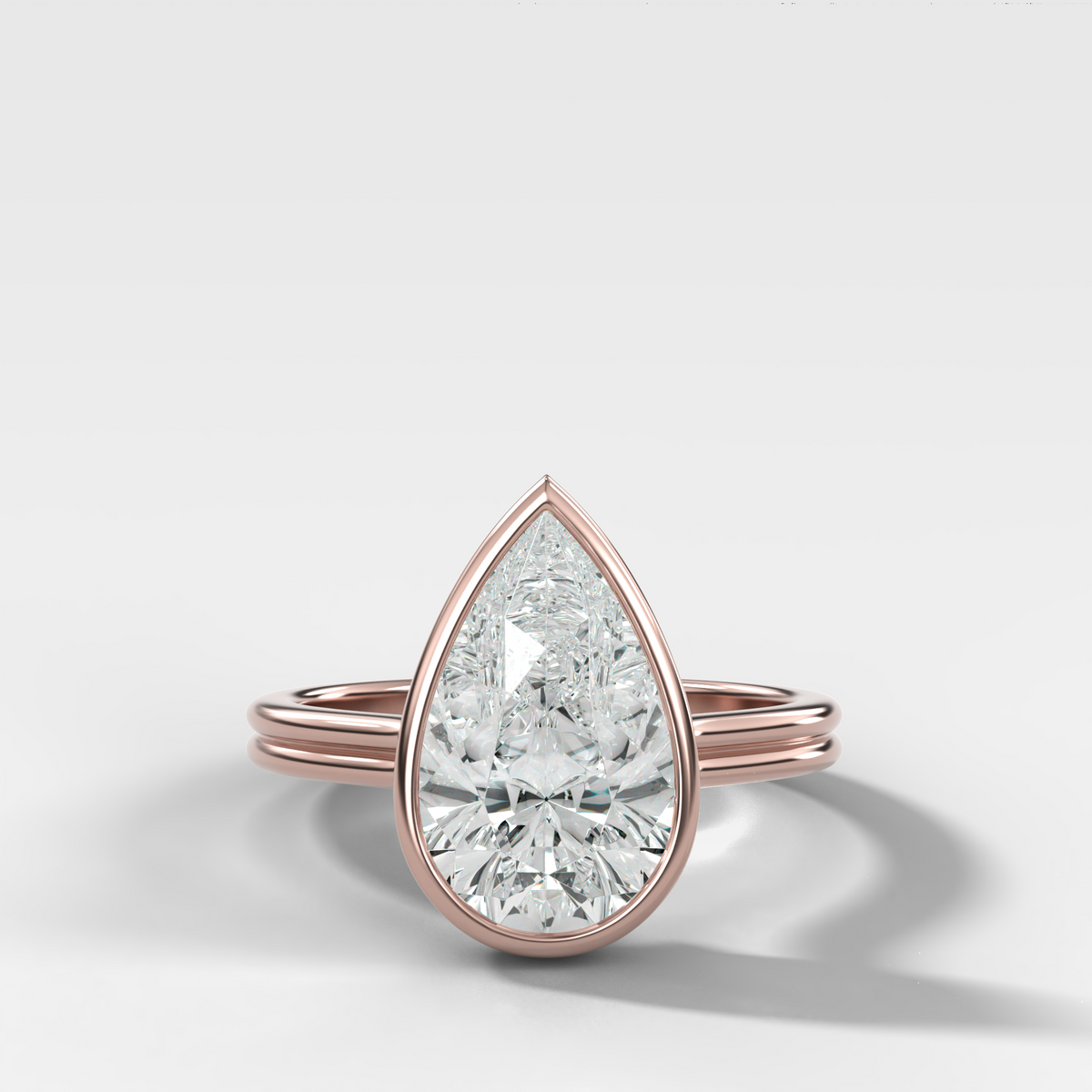 Double Row Penumbra Bezel Engagement Ring With Pear Cut Diamond