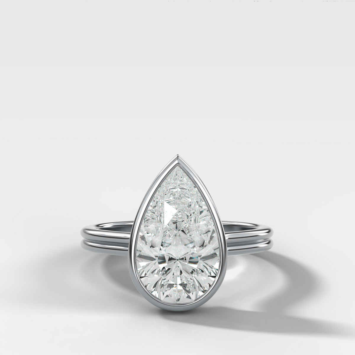 Double Row Penumbra Bezel Engagement Ring With Pear Cut Diamond