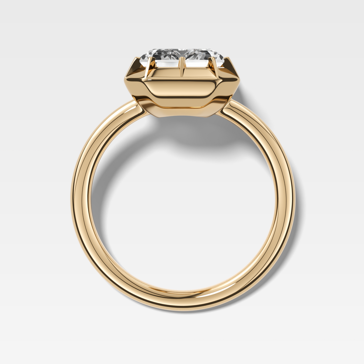 Button Back Solitaire Engagement Ring With an Emerald Cut Diamond