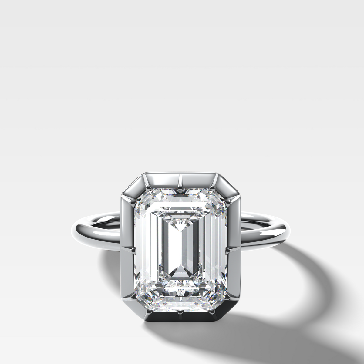 Button Back Solitaire Engagement Ring With an Emerald Cut Diamond
