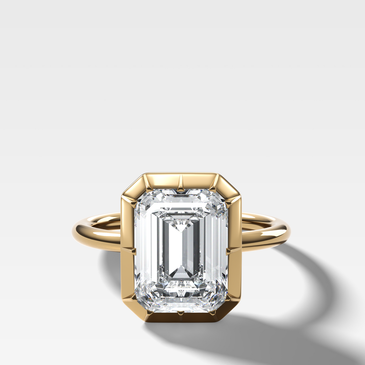 Button Back Solitaire Engagement Ring With an Emerald Cut Diamond