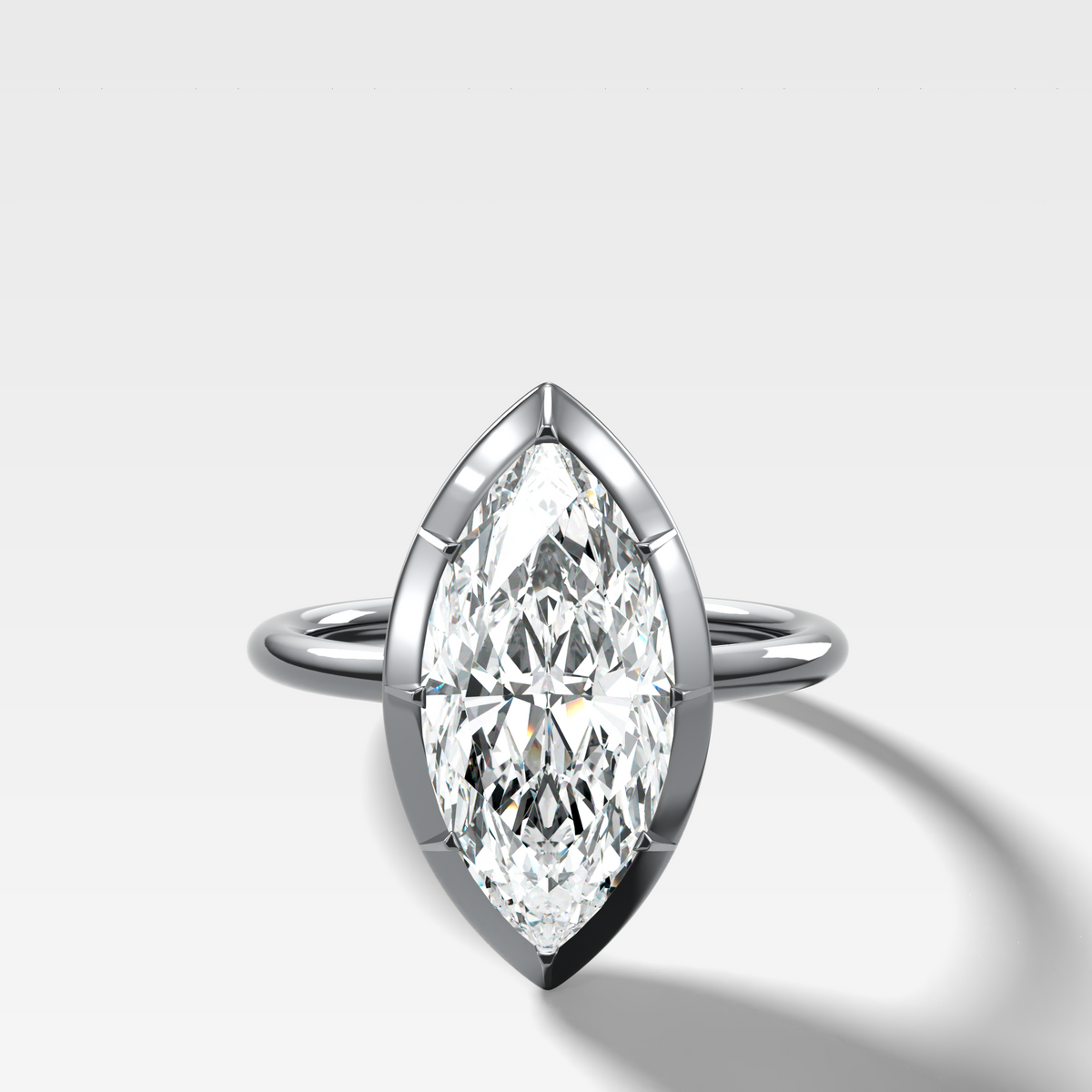 Button Back Solitaire Engagement Ring With a Marquise Cut Diamond