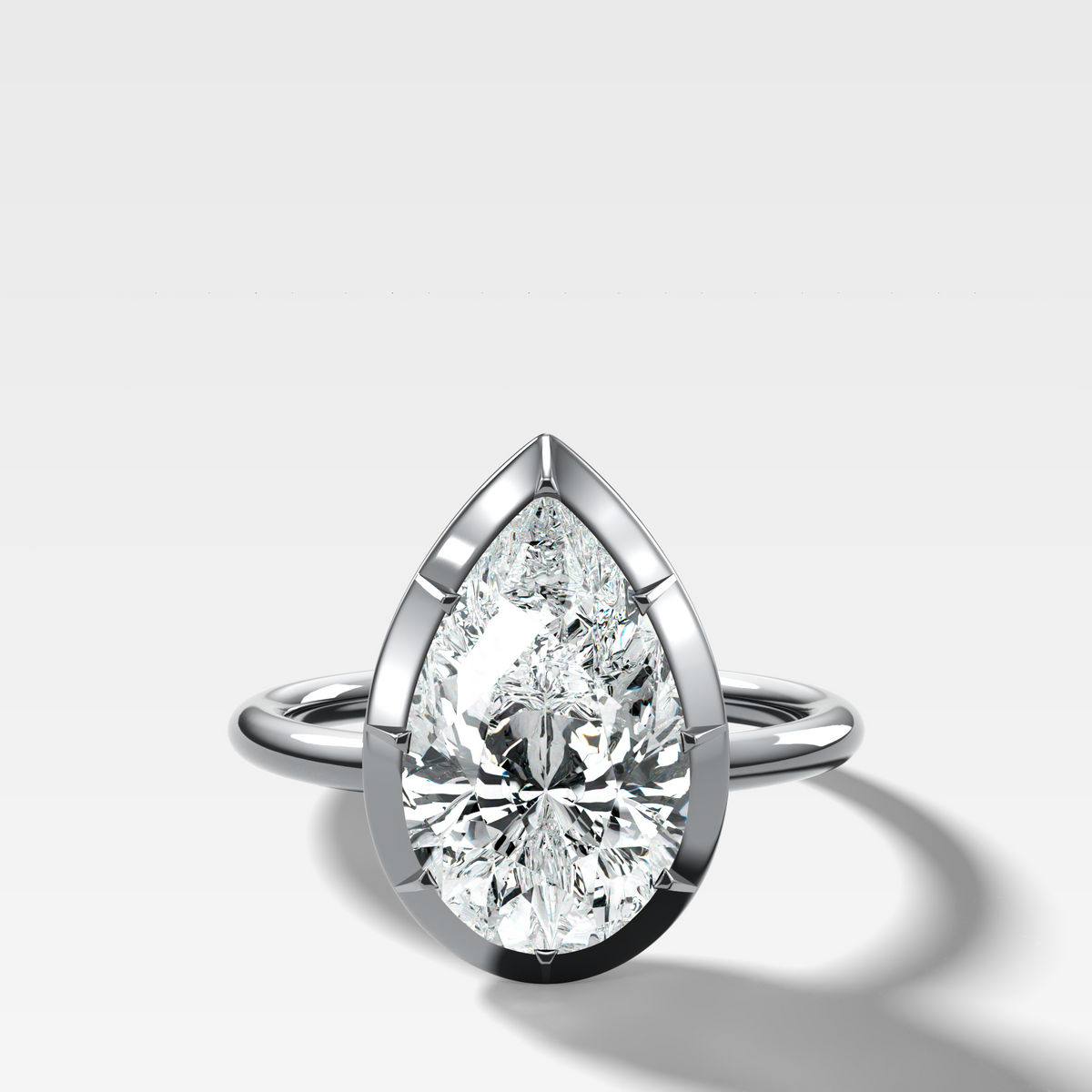 Button Back Solitaire Engagement Ring With a Pear Cut Diamond