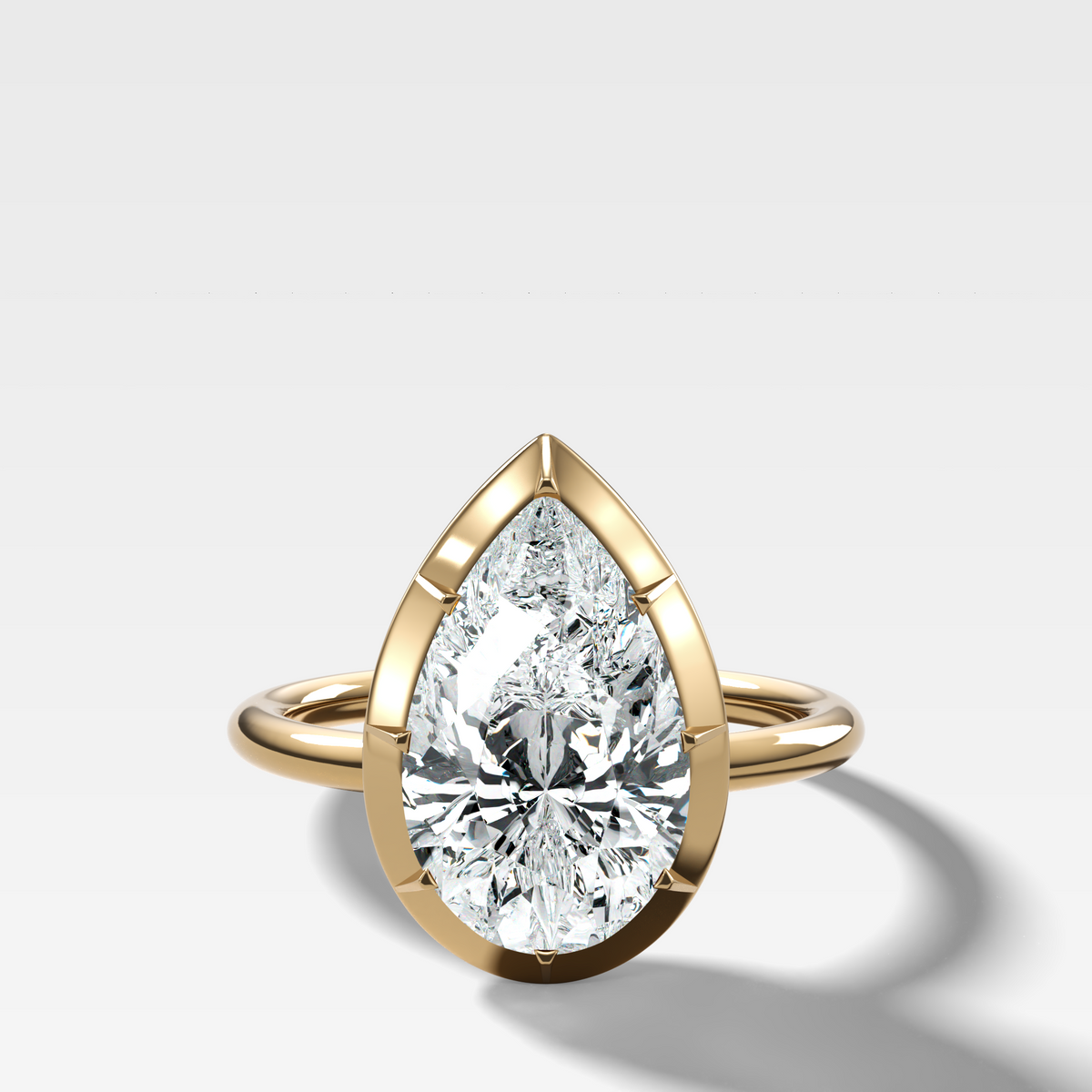 Button Back Solitaire Engagement Ring With a Pear Cut Diamond