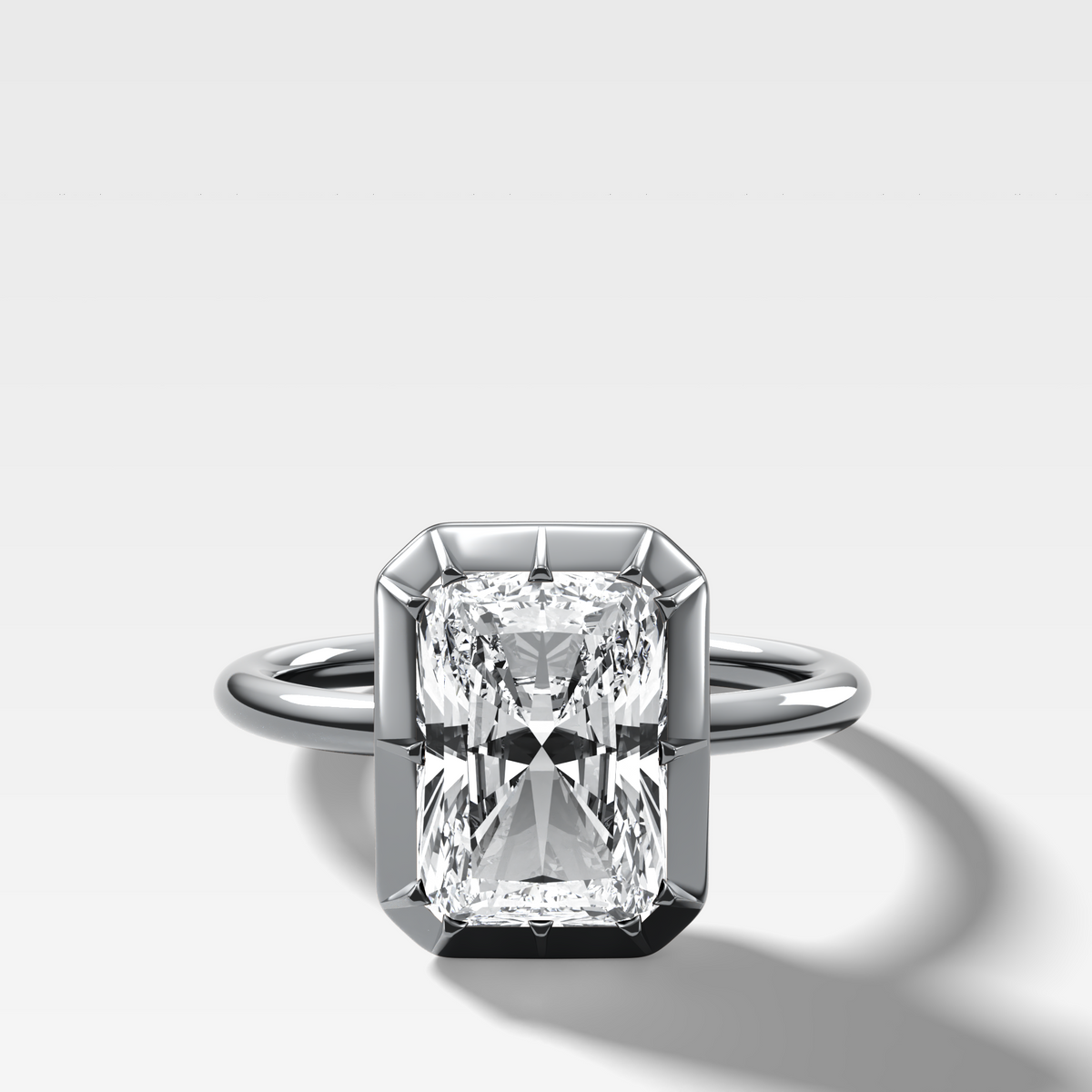 Button Back Solitaire Engagement Ring With an Elongated Radiant Cut Diamond