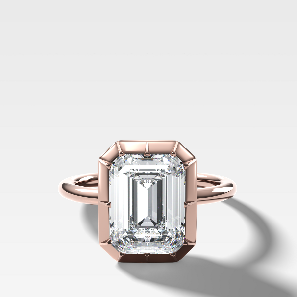 Button Back Solitaire Engagement Ring With an Emerald Cut Diamond