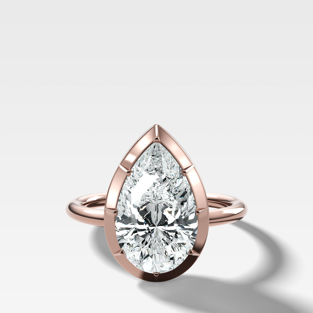 Button Back Solitaire Engagement Ring With a Pear Cut Diamond