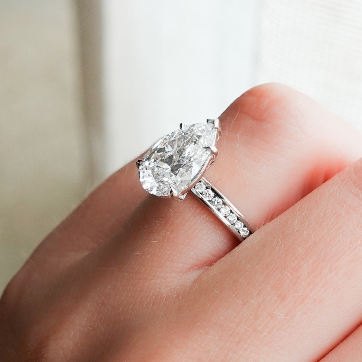 Petite Channel Set Engagement Ring with Pear Cut Diamond
