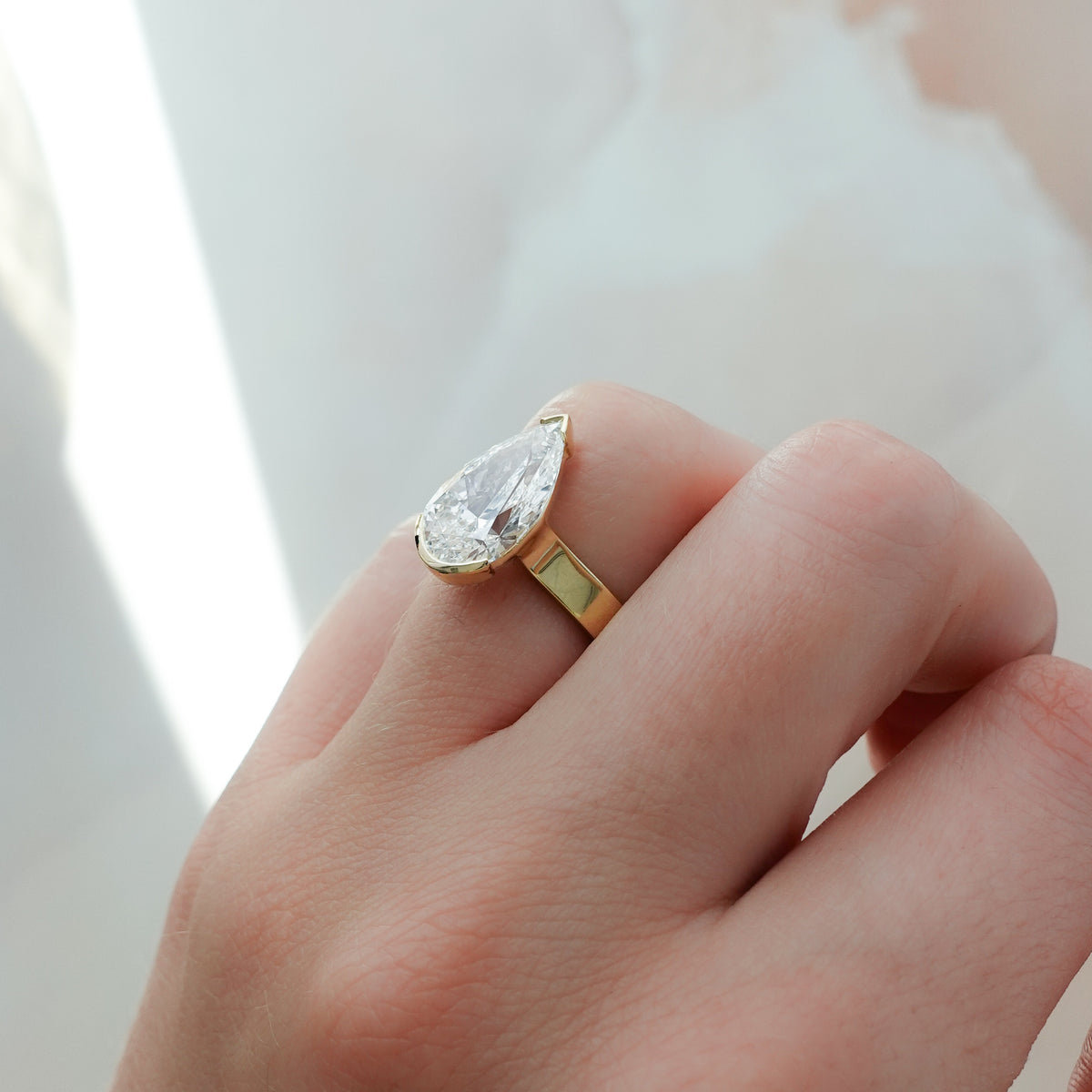 Finest Half Bezel Solitaire Engagement Ring With Pear Cut Diamond
