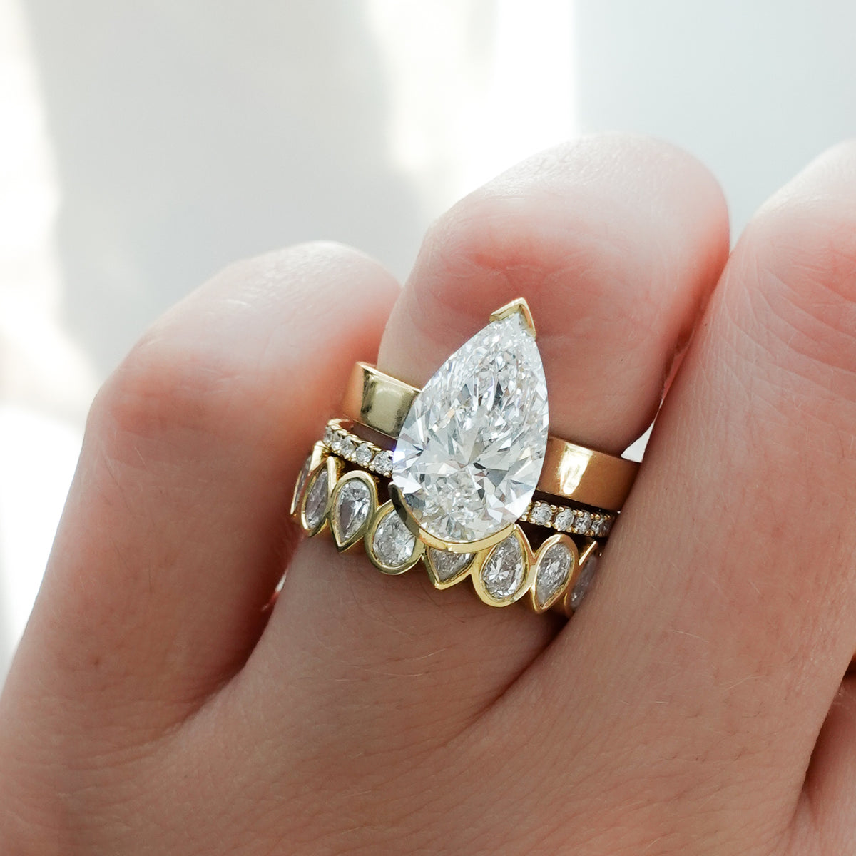 Finest Half Bezel Solitaire Engagement Ring With Pear Cut Diamond