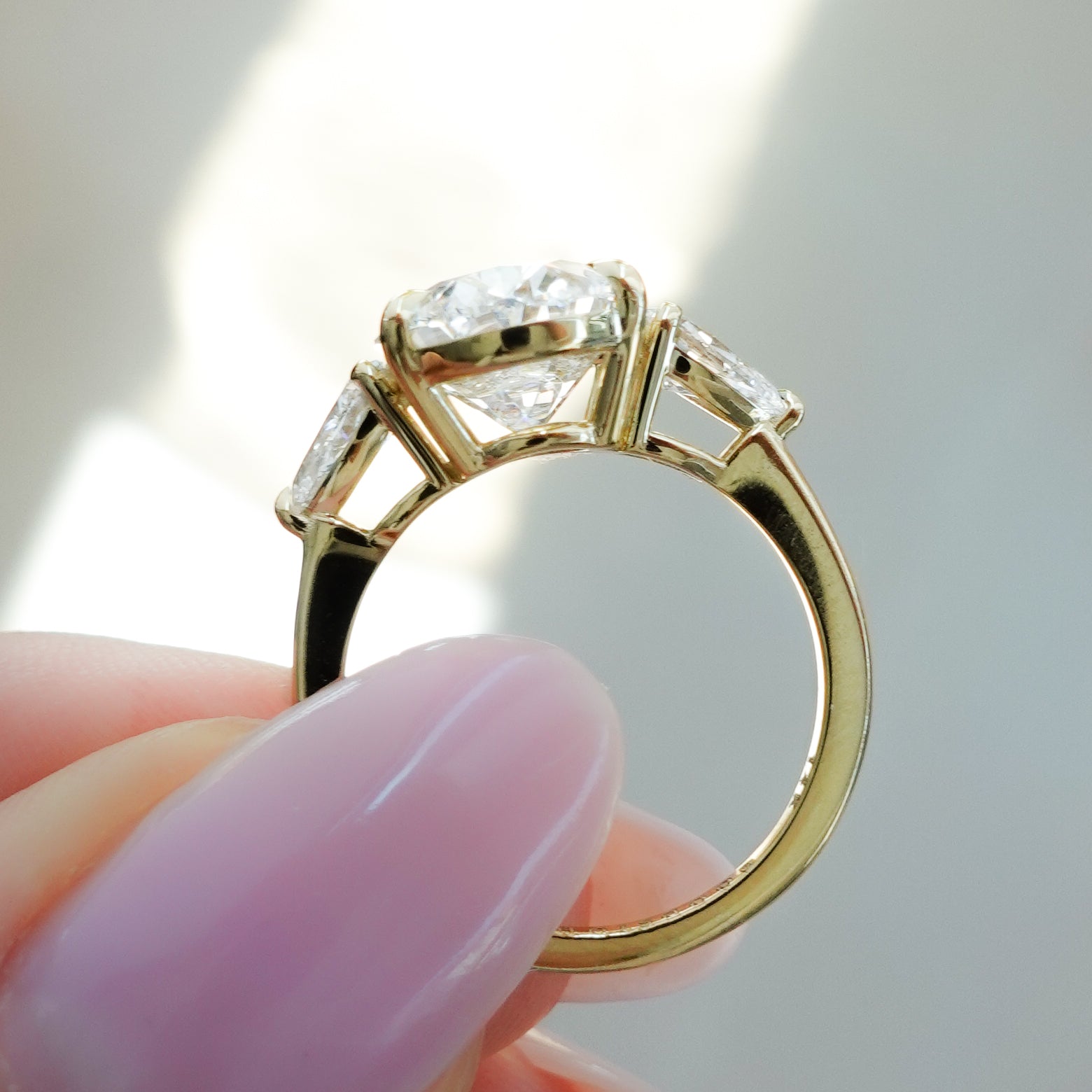 Three Stone Engagement Ring With Pear Side Stones And Oval Cut by Good Stone in Yellow Gold