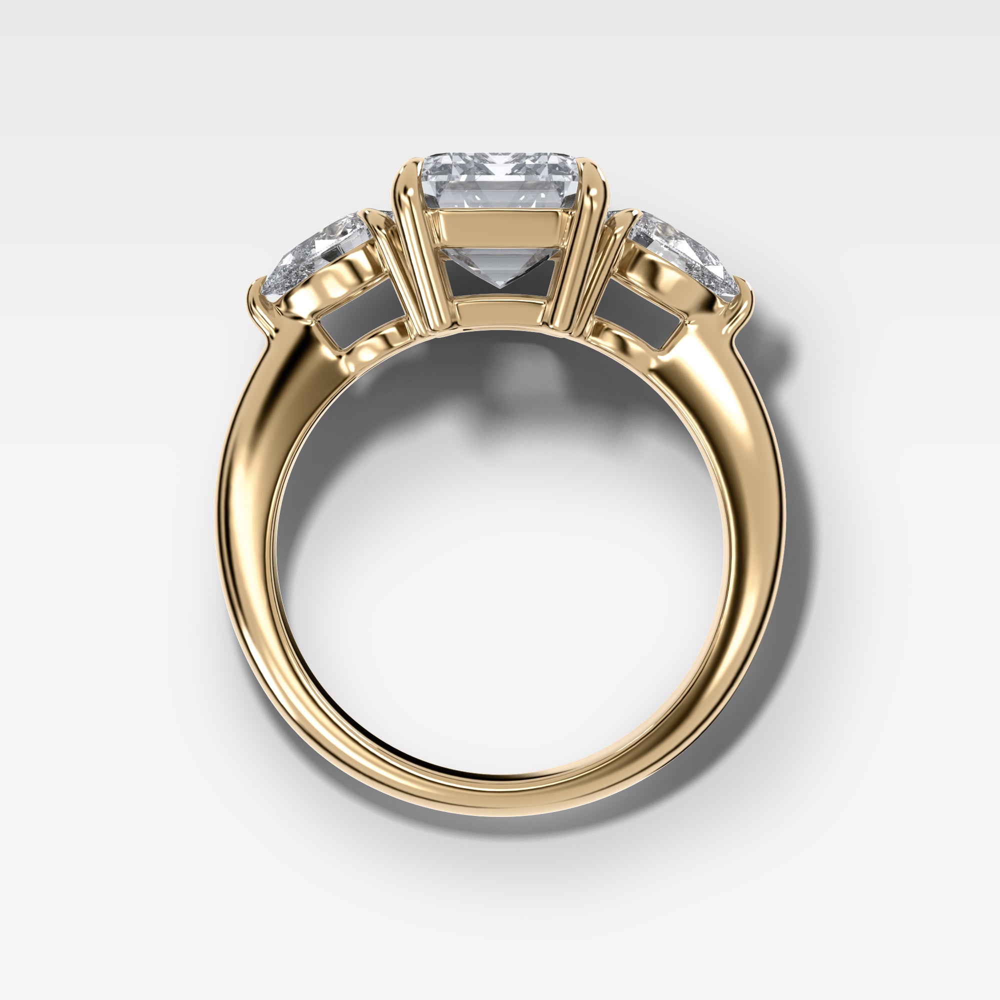 Three Stone Engagement Ring With Pear Side Stones and Emerald Cut by Good Stone in Yellow Gold
