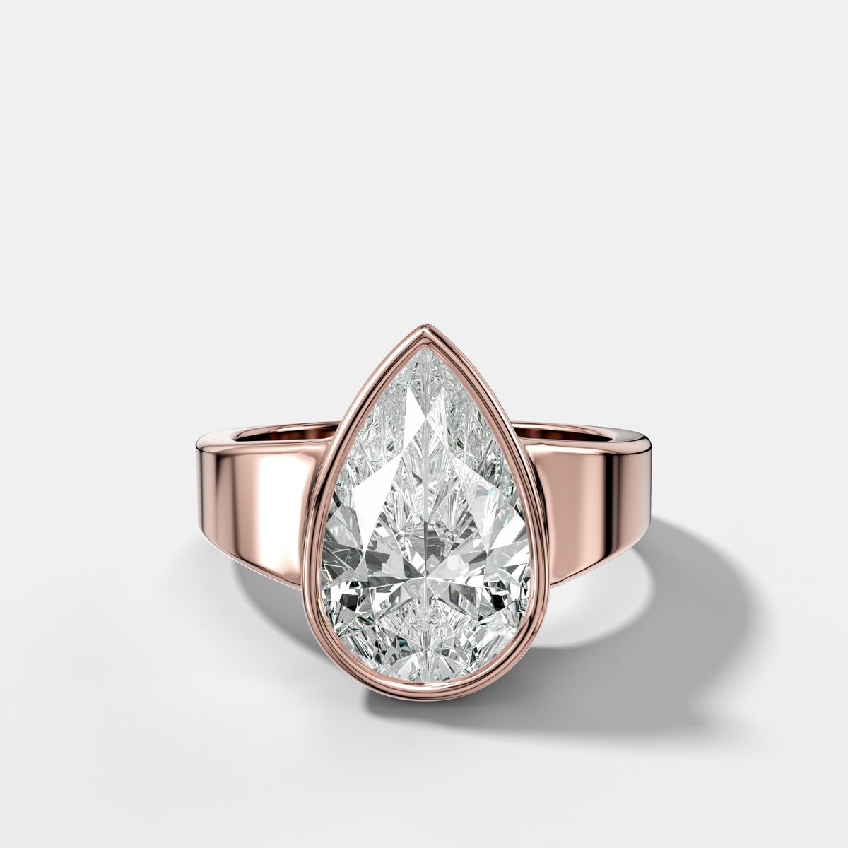 Finest Tapered Bezel Set Engagement Ring With Pear Cut Diamond