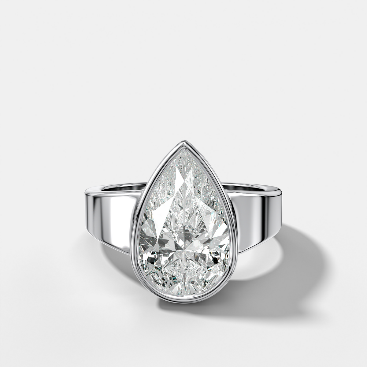 Finest Tapered Bezel Set Engagement Ring With Pear Cut Diamond