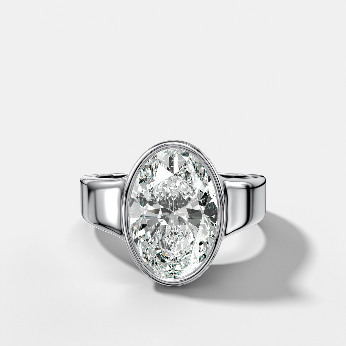 Finest Tapered Bezel Set Engagement Ring With Oval Cut Diamond