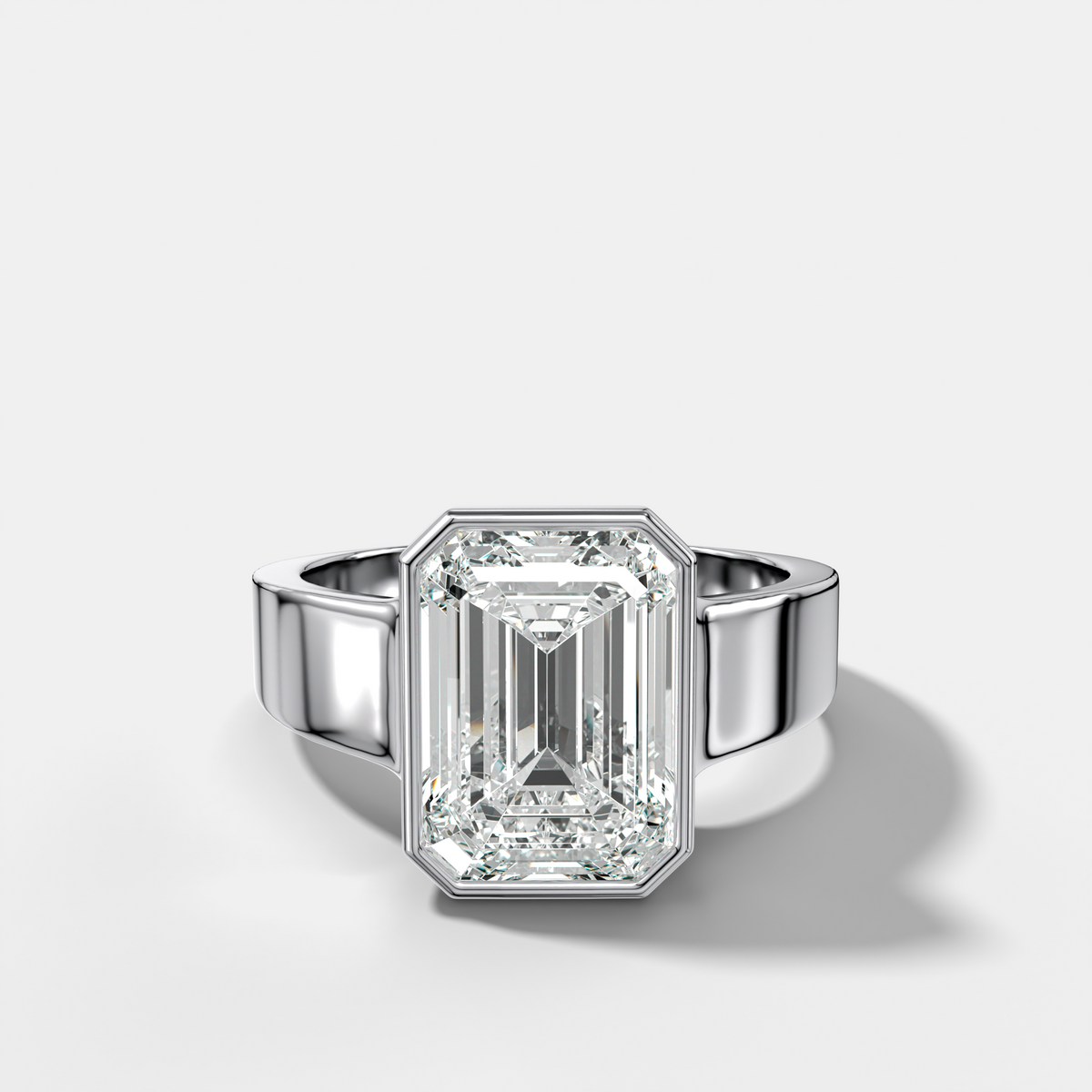 Finest Tapered Bezel Set Engagement Ring With Emerald Cut Diamond