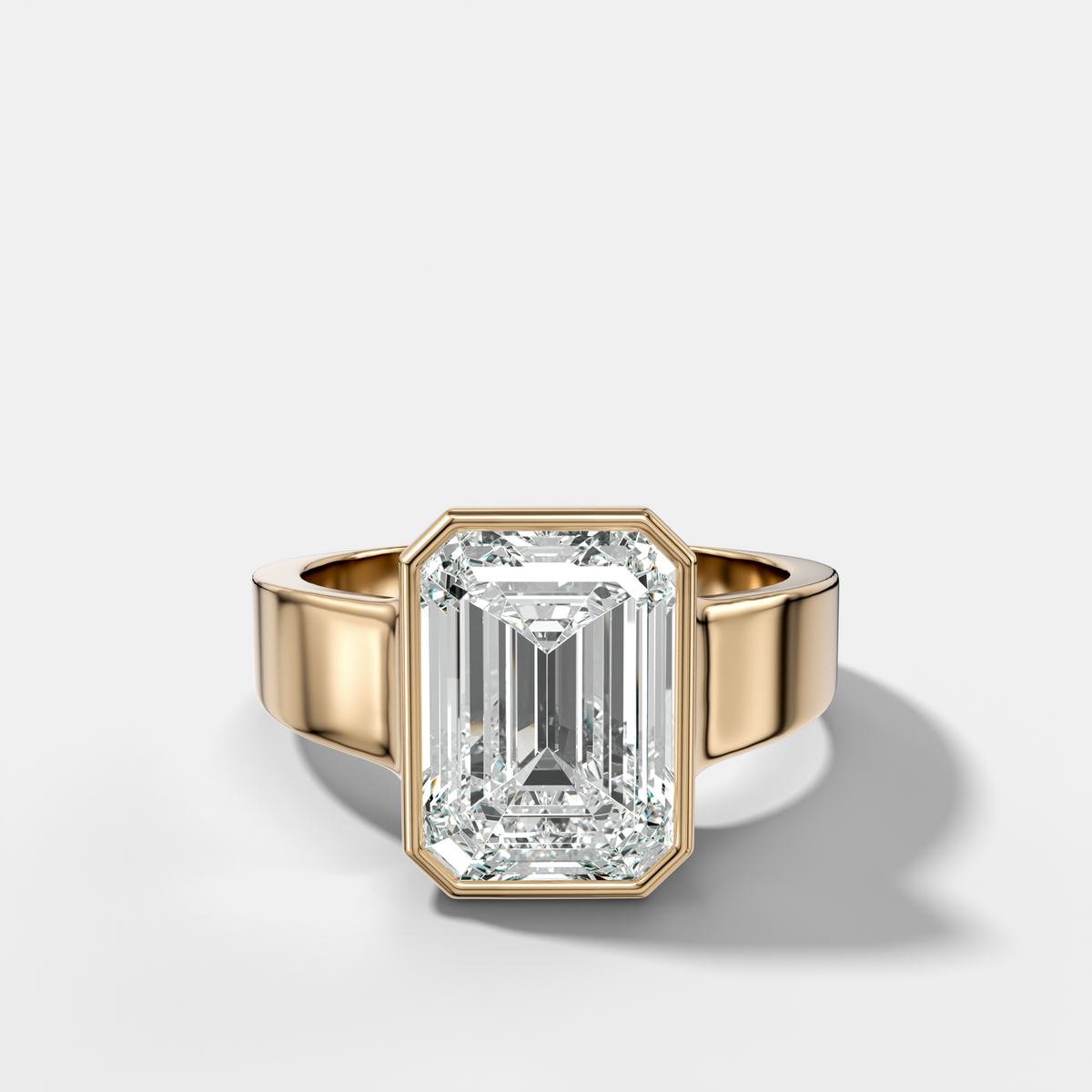 Finest Tapered Bezel Set Engagement Ring With Emerald Cut Diamond