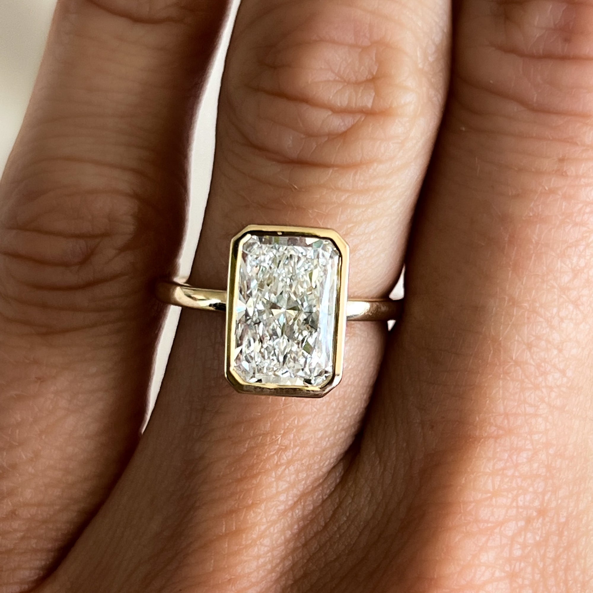 Bezel Penumbra Solitaire With Radiant Cut by Good Stone in Yellow Gold