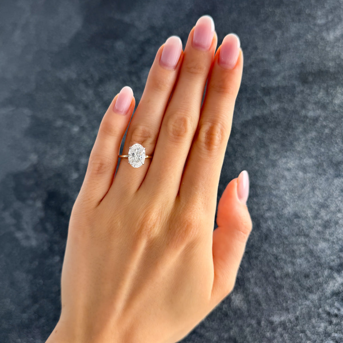 Thin + Simple Solitaire Engagement Ring With Oval Cut Diamond