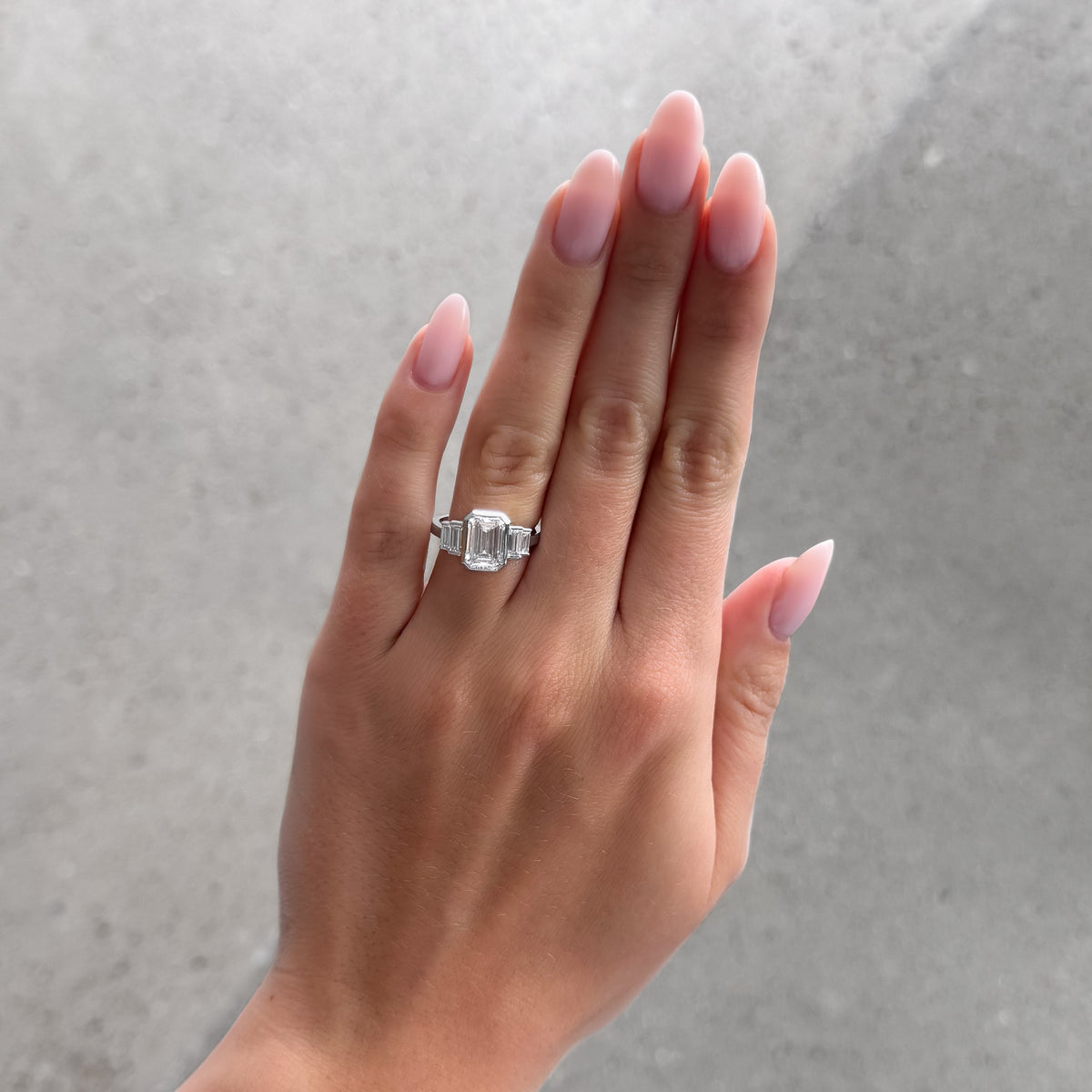 Five Stone Engagement Ring with Half Bezel Baguette Side Stones and Bezel Set Emerald Cut Diamond