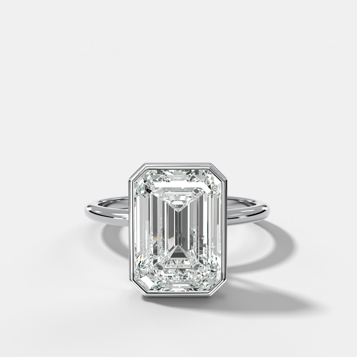 Penumbra Bezel Hidden Halo Engagement Ring with Emerald Cut