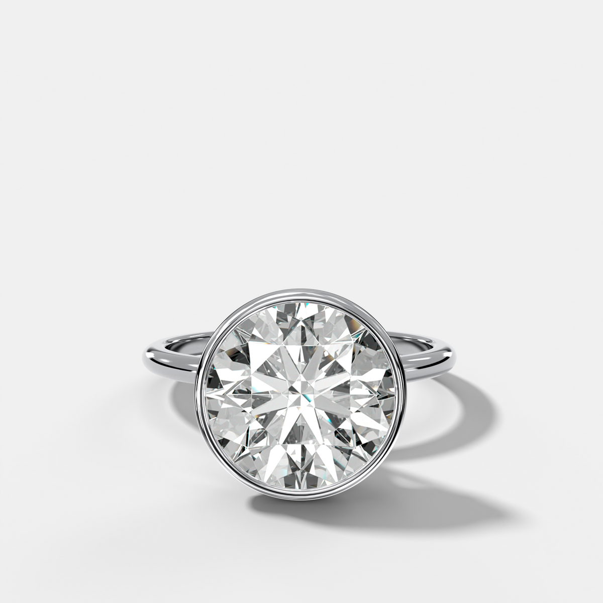 Penumbra Bezel Hidden Halo Engagement Ring with Round Cut