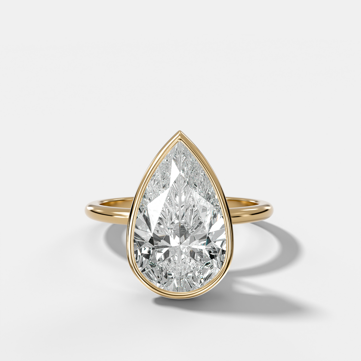 Penumbra Bezel Hidden Halo Engagement Ring with Pear Cut