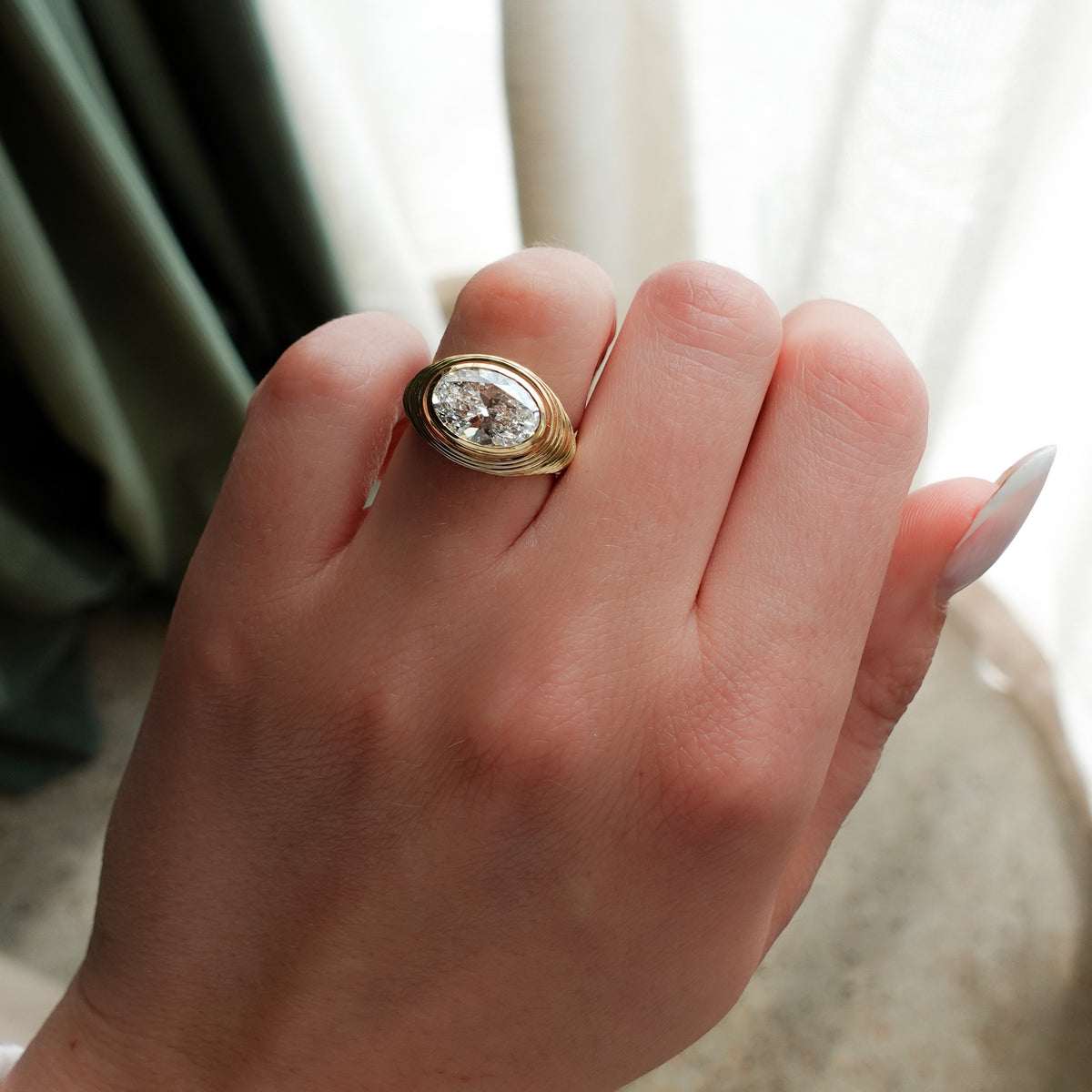 Ripple Solitaire Engagement Ring with East West Oval Cut Diamond