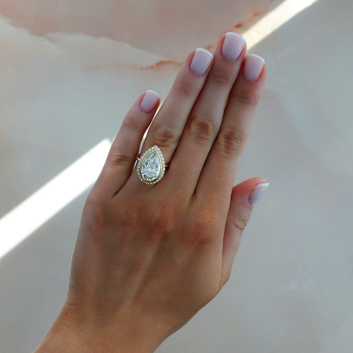 Bezel Set Halo Engagement Ring With Pear Cut Diamond - GOODSTONE