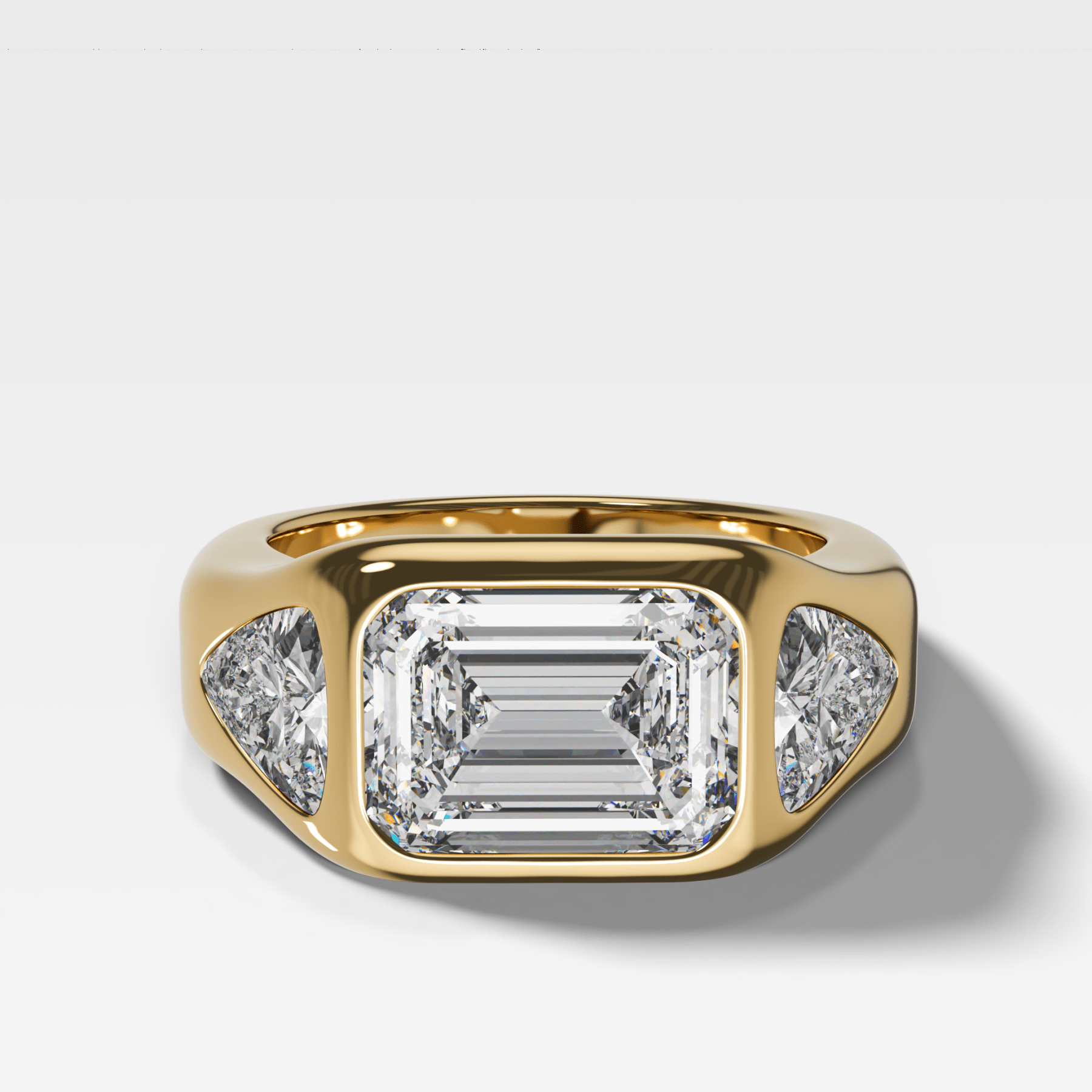 Burnished Three Stone Engagement Ring with Trilliant Sides and East West 2.53ct Lab Grown Emerald Cut Diamond - GOODSTONE