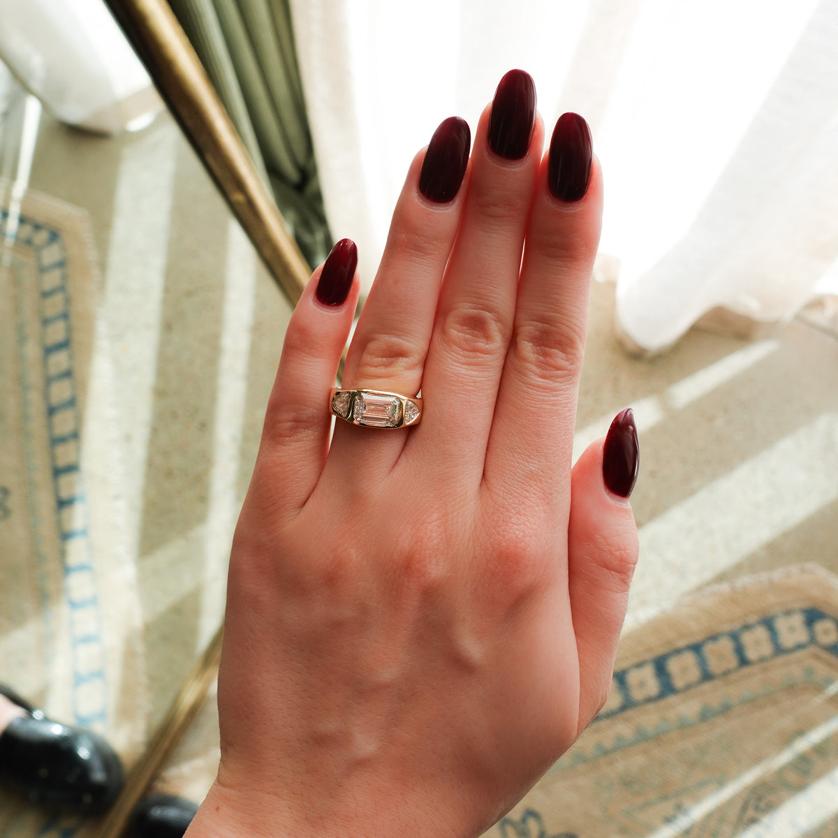 Burnished Three Stone Engagement Ring with Trilliant Sides and East West Emerald Cut Diamond