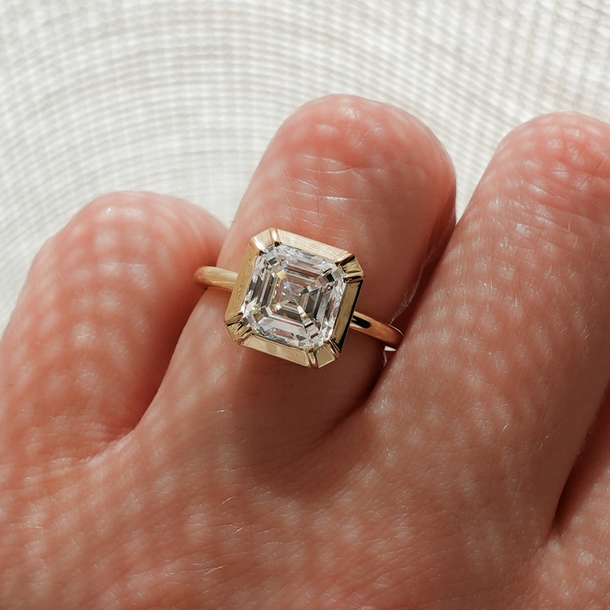 Button Back Solitaire Engagement Ring With an Asscher Cut Diamond