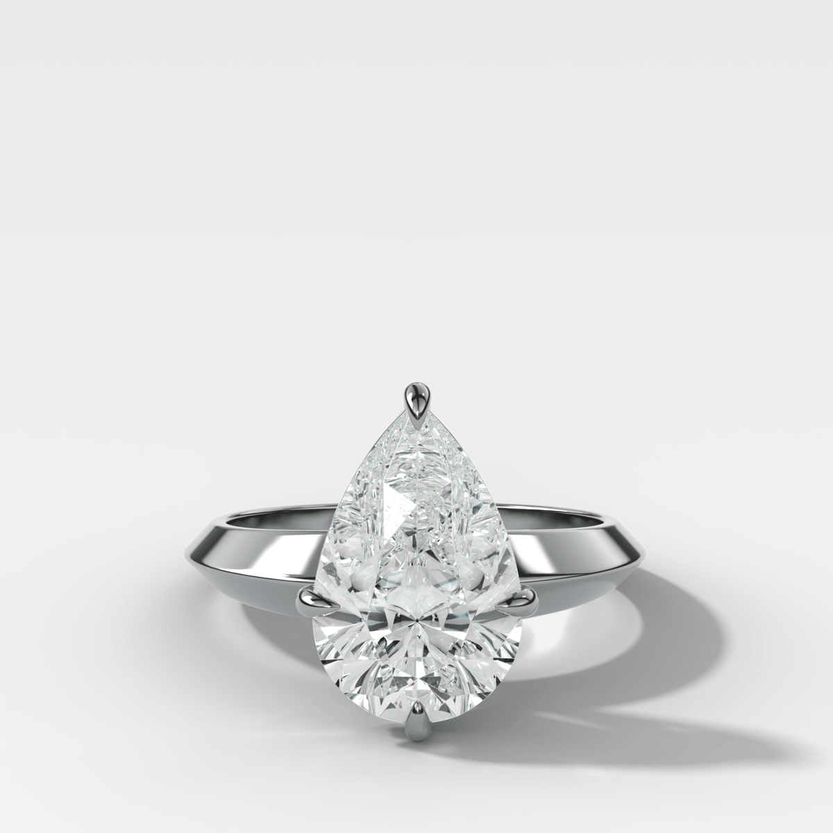 Compass Tapered Butter Knife Finest Solitaire Engagement Ring With a Pear Cut Diamond - GOODSTONE