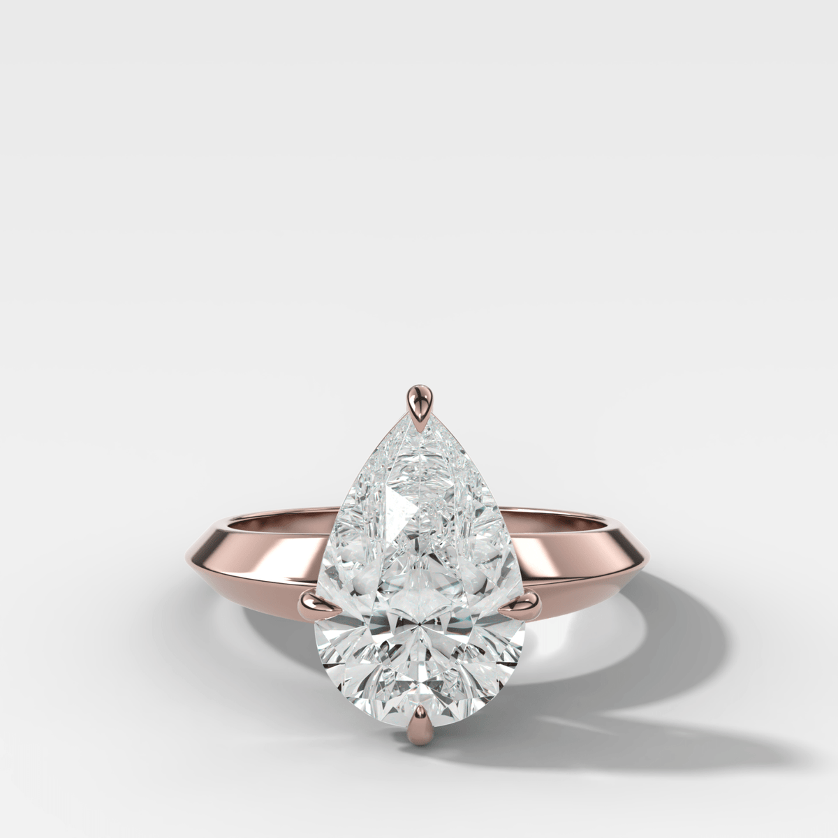 Compass Tapered Butter Knife Finest Solitaire Engagement Ring With a Pear Cut Diamond - GOODSTONE