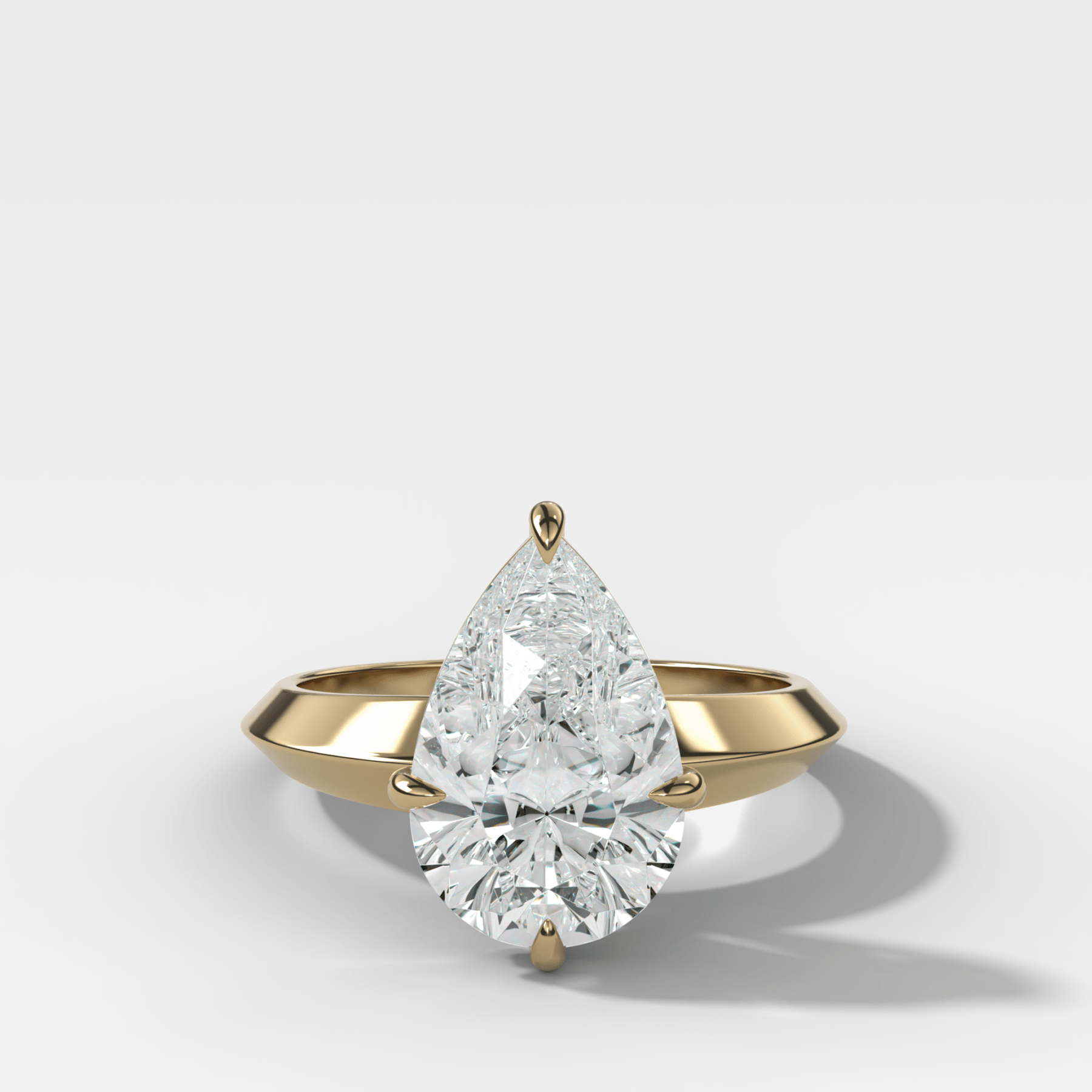 Compass Tapered Butter Knife Finest Solitaire Engagement Ring With a Pear Cut Diamond - GOODSTONE