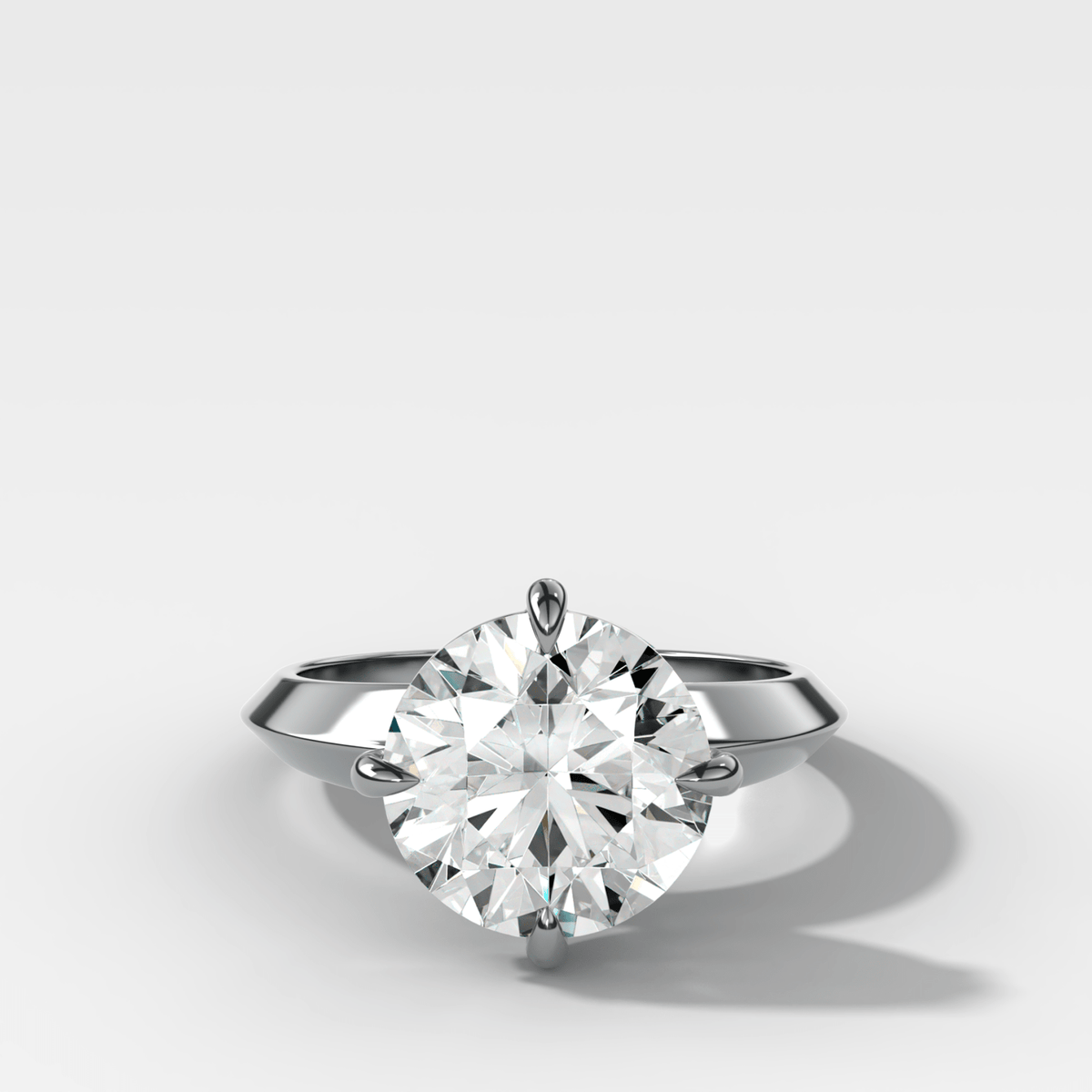 Compass Tapered Butter Knife Finest Solitaire Engagement Ring With a Round Cut Diamond - GOODSTONE