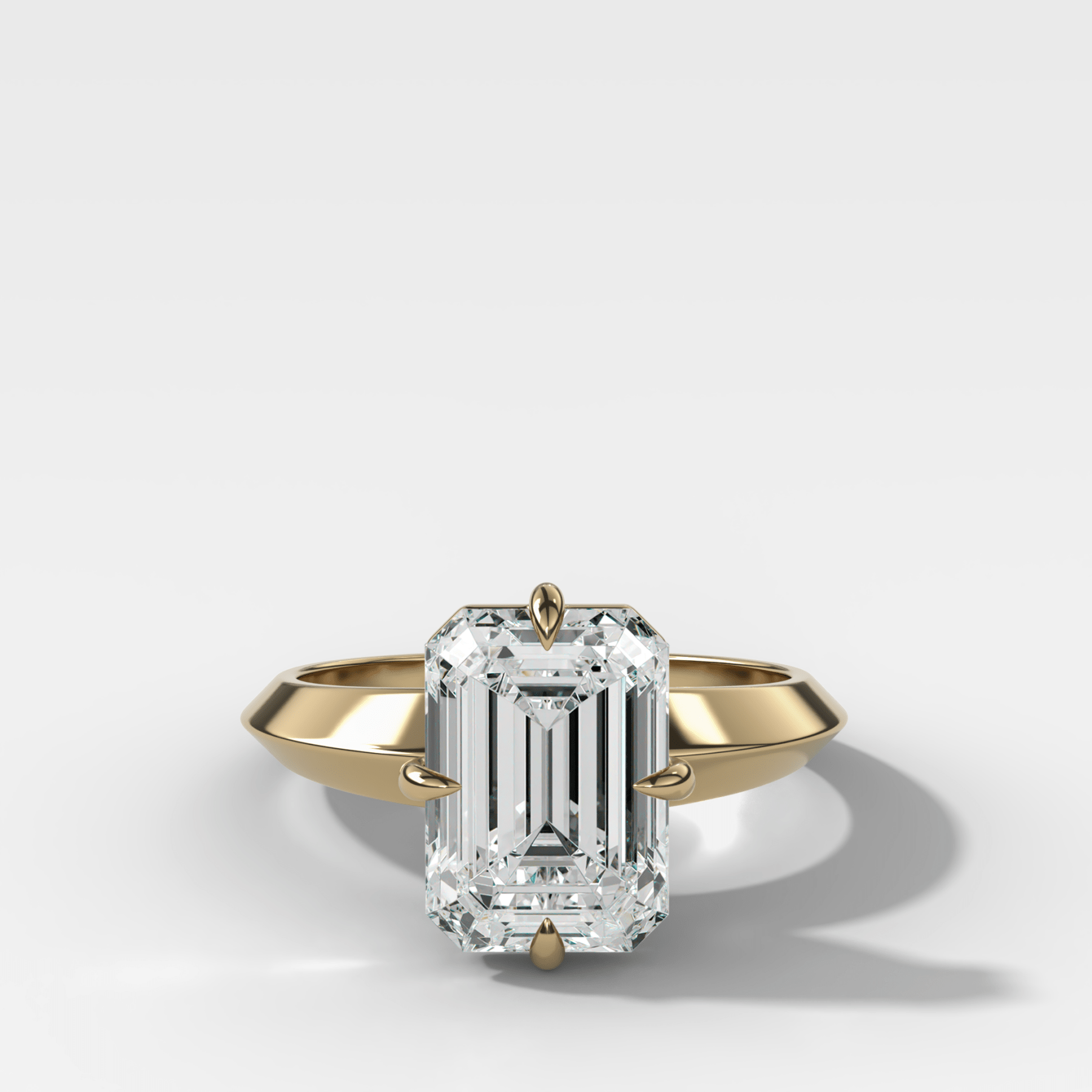 Compass Tapered Butter Knife Finest Solitaire Engagement Ring With an Emerald Cut Diamond - GOODSTONE