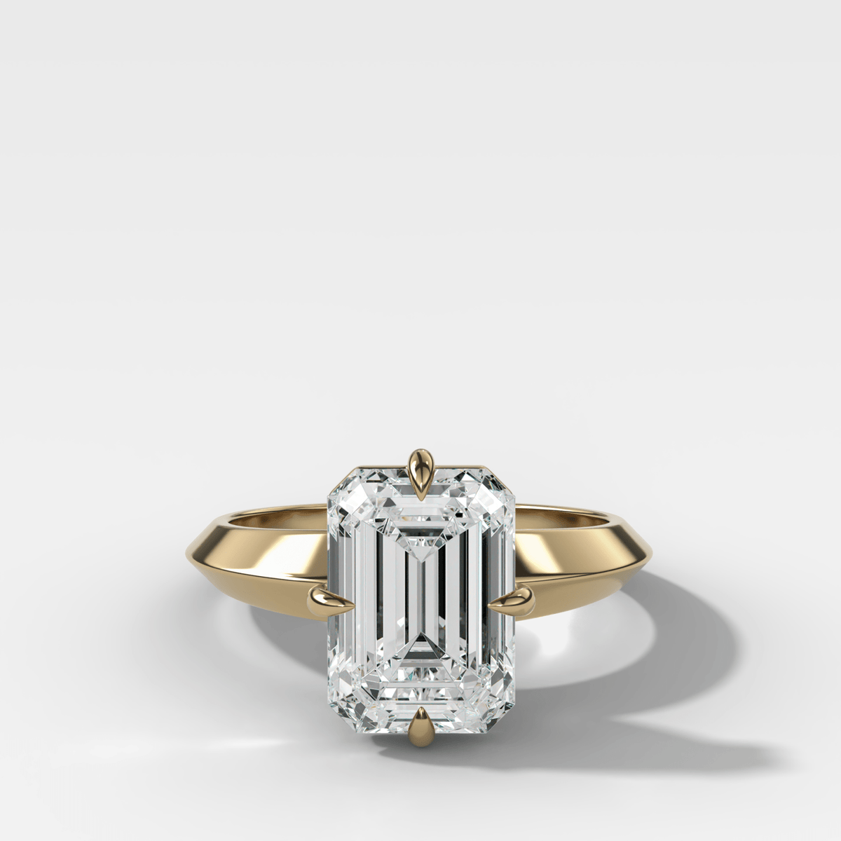 Compass Tapered Butter Knife Finest Solitaire Engagement Ring With an Emerald Cut Diamond - GOODSTONE