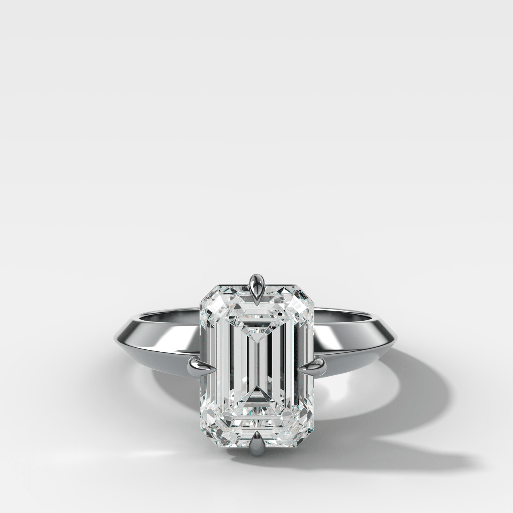 Compass Tapered Butter Knife Finest Solitaire Engagement Ring With an Emerald Cut Diamond - GOODSTONE