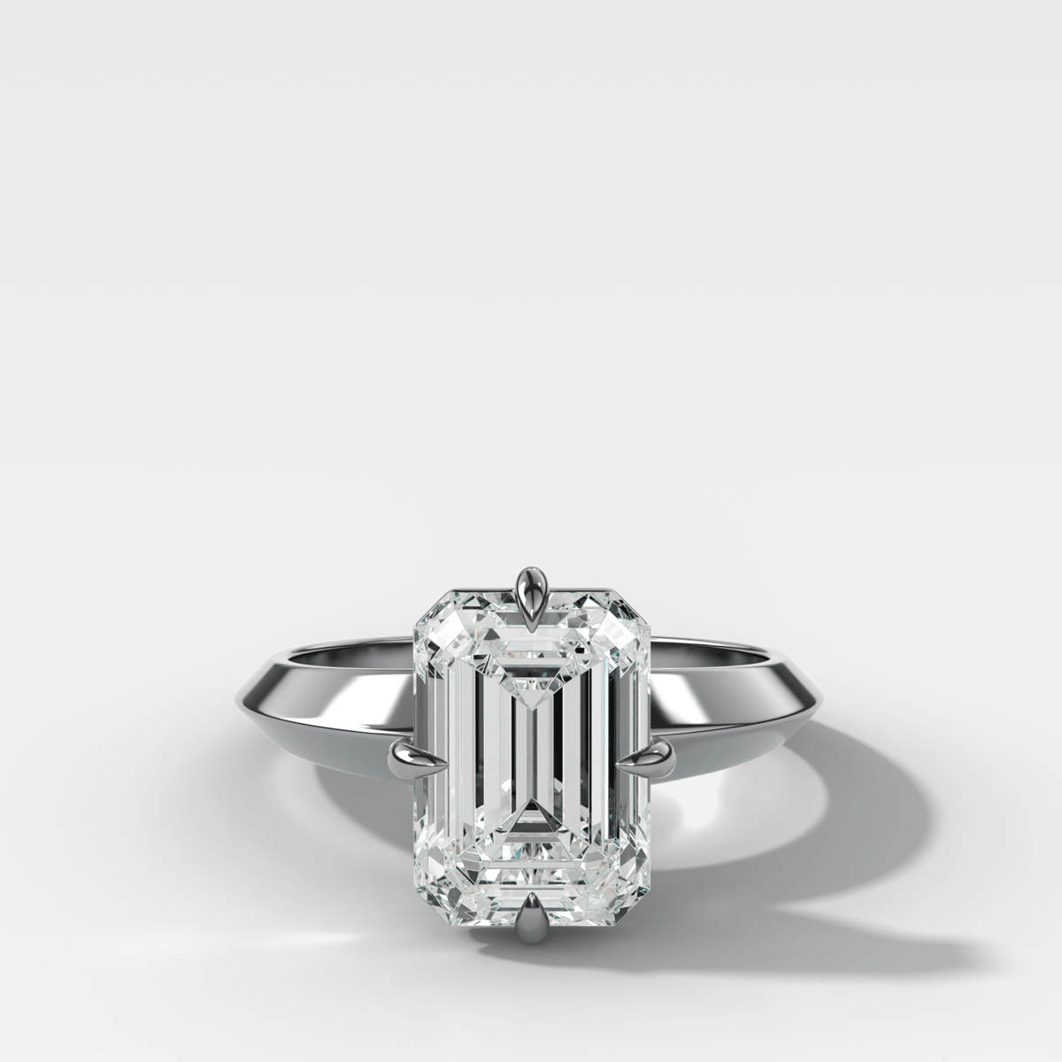 Compass Tapered Butter Knife Finest Solitaire Engagement Ring With an Emerald Cut Diamond - GOODSTONE