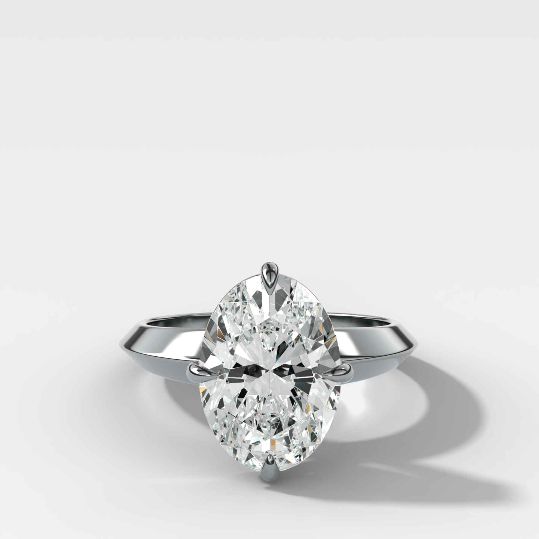 Compass Tapered Butter Knife Finest Solitaire Engagement Ring With an Oval Cut Diamond - GOODSTONE