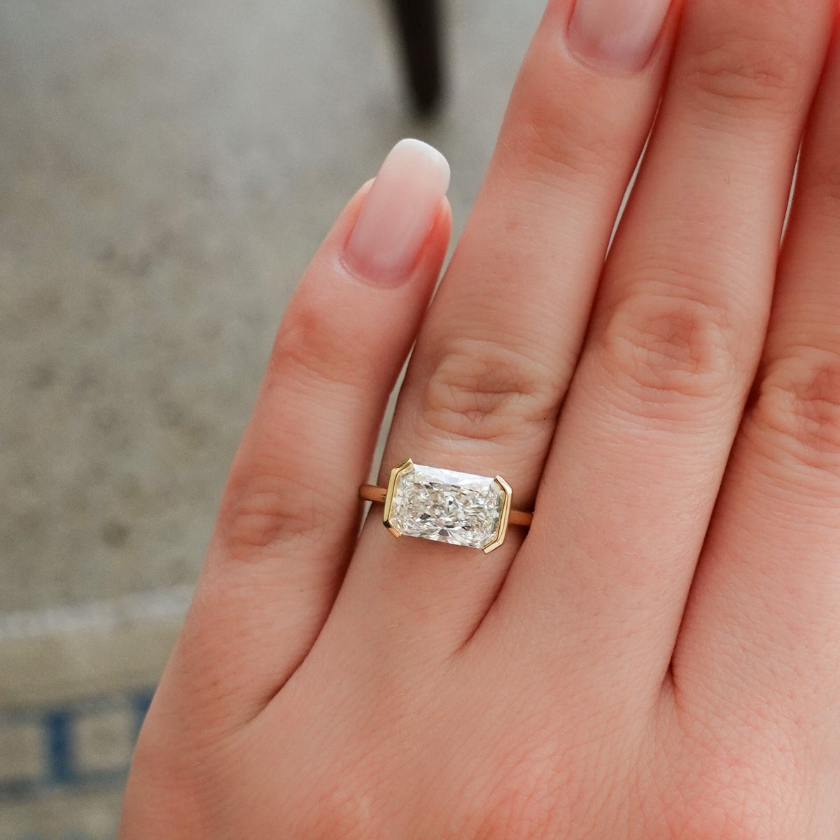 East West Half Bezel Solitaire Engagement Ring With 4.07ct Radiant Cut Lab Grown Diamond - GOODSTONE