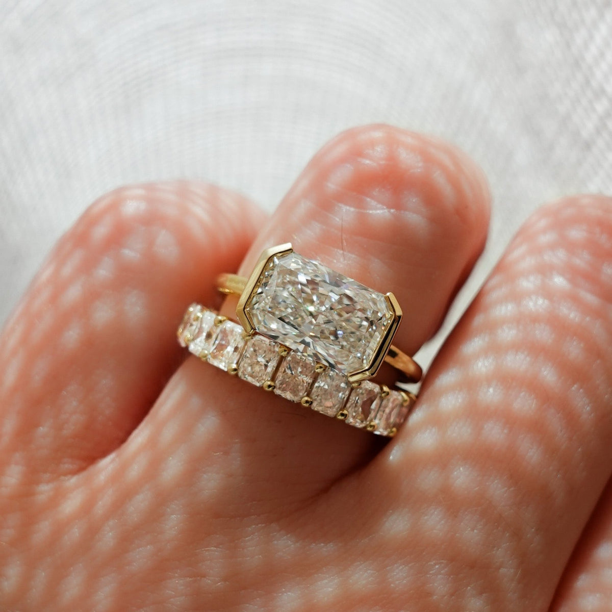 East West Half Bezel Solitaire Engagement Ring With Elongated Radiant Cut Diamond - GOODSTONE